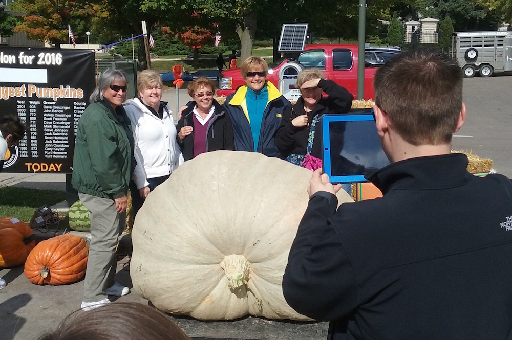 Visitors pose with the winning pumpkin at the 2016 Lake Geneva Oktoberfest contest. Dan Plutchak photo.