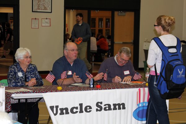 In this 2012 photo from the Reality Store Facebook page, students begin their journey by paying their taxes.