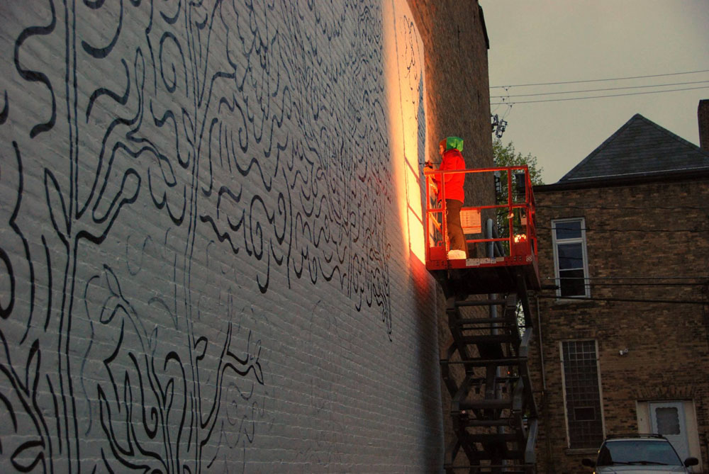 Appleton artist Elyse-Krista Mische begins work on the mural that will be completed April 29, 2017 during Bazaar After Dark. Photo by Tony Penterman. Photo by Cherie Mytas