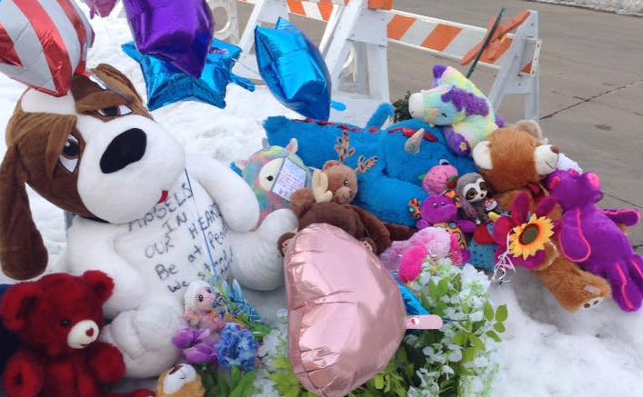 Memorial for Danielle and William Beyer outside of their home on Crooks Avenue in Kaukauna, Photo by Jason Sheaffer‎