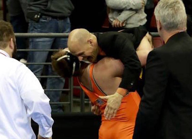 Keaten Kluever hugs his coach after his state championship win. Paul Stumpf photo.