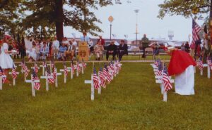 Poppy Princesses place flags to the fallen during a 1984 Memorial Day ceremony in Kaukauna. Photo by Dan Plutchak.