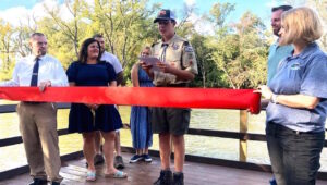 Boy Scout Brody Riehl makes remarks during the ribbon cutting for the fishing pier he rebuilt at the 1000 Islands Environmental Center in Kaukauna
