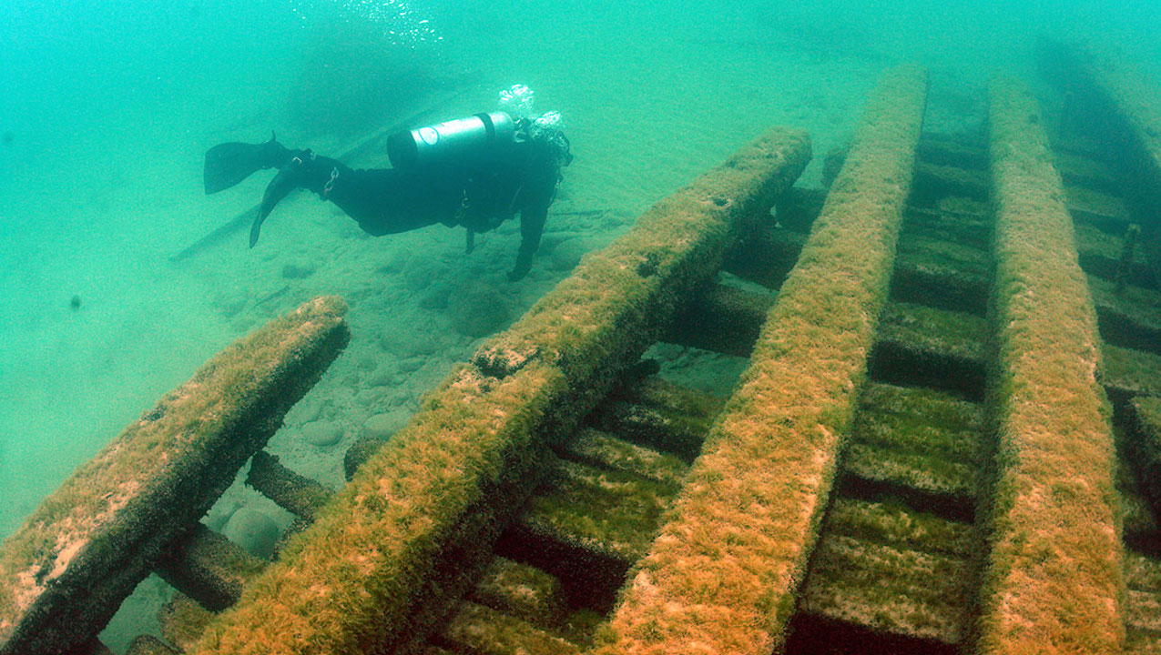 An archaeologist investigates floor keelsons near the bow of the Appomattox, which sank near Milwaukee in 1905. Photo by Wisconsin HIstorical Society, Maritime Preservation and Archaeology Program