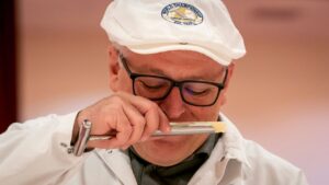 Roland Sahli of Gourmino AG examines the aroma of a piece of cheese at the 2022 World Championship Cheese Contest in Madison, Wisconsin. Photo courtesy World Championship Cheese Contest on Facebook.