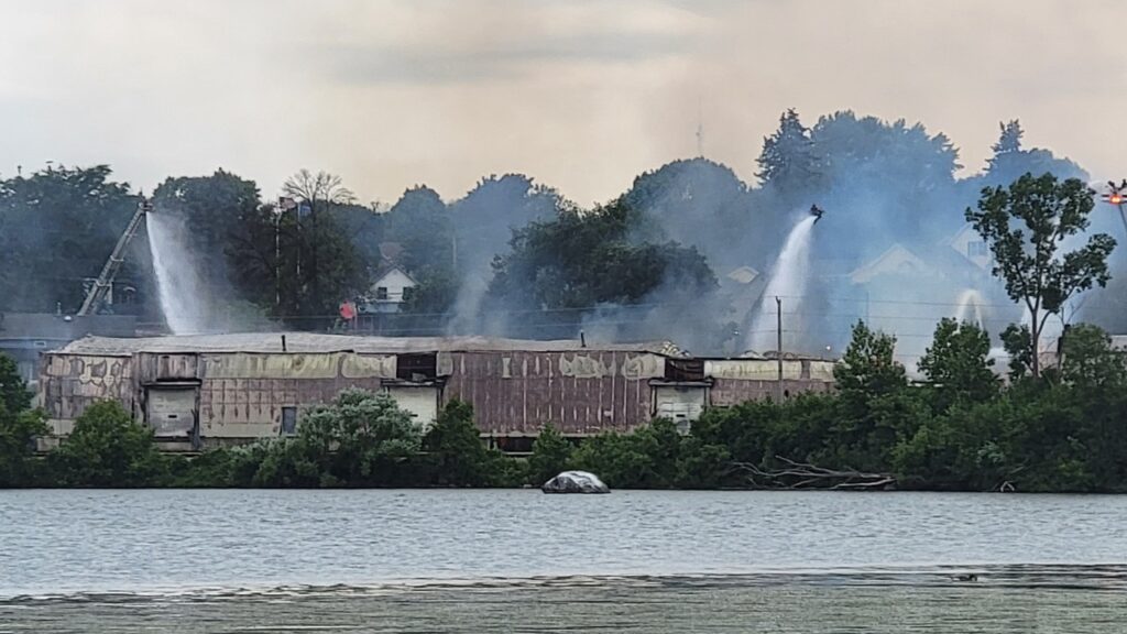 Firefighters dump wanter on a warehouse Friday at Warehouse Specialists in Combined Locks. Photos by Victor Olson used with permission