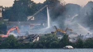 Excavators and firefighters with arial and ground hoses work together to put out the fire at WSI Warehouse in Combined Locks. Photos courtesy Victor Olson