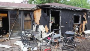A large boom alerted neighbors to smoke and flames in a Kaukauna garage Friday night that led to about $100,000 in damage.