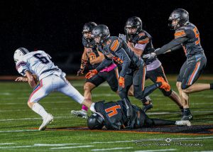 Kaukauna defenders make a tackle during the 2023 regular season finale win over Appleton East. Photo by Dave Vissers. More photos at Dave Vissers Photography