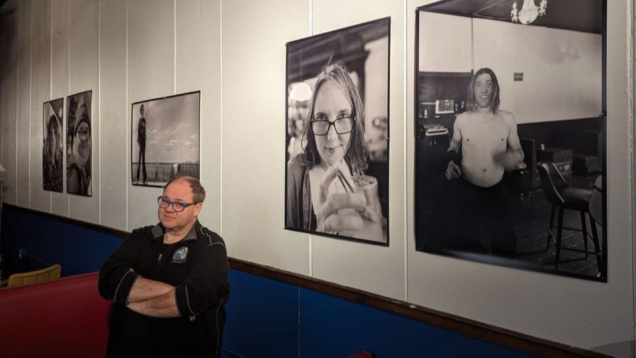 John Brogan with a collecton of his black-and-white portraits.