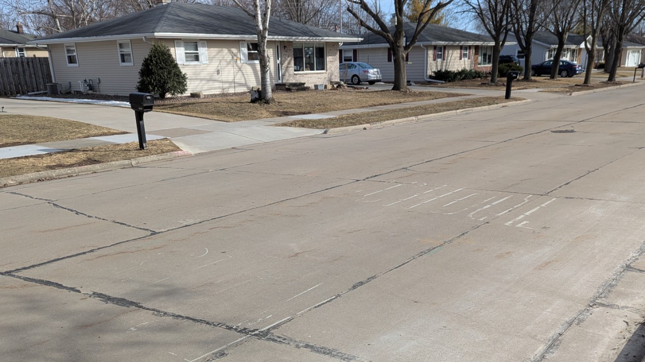 The school zone paint on the pavement near Quinney and Tanner is nearly worn off. Photo by Jamie Smithey.